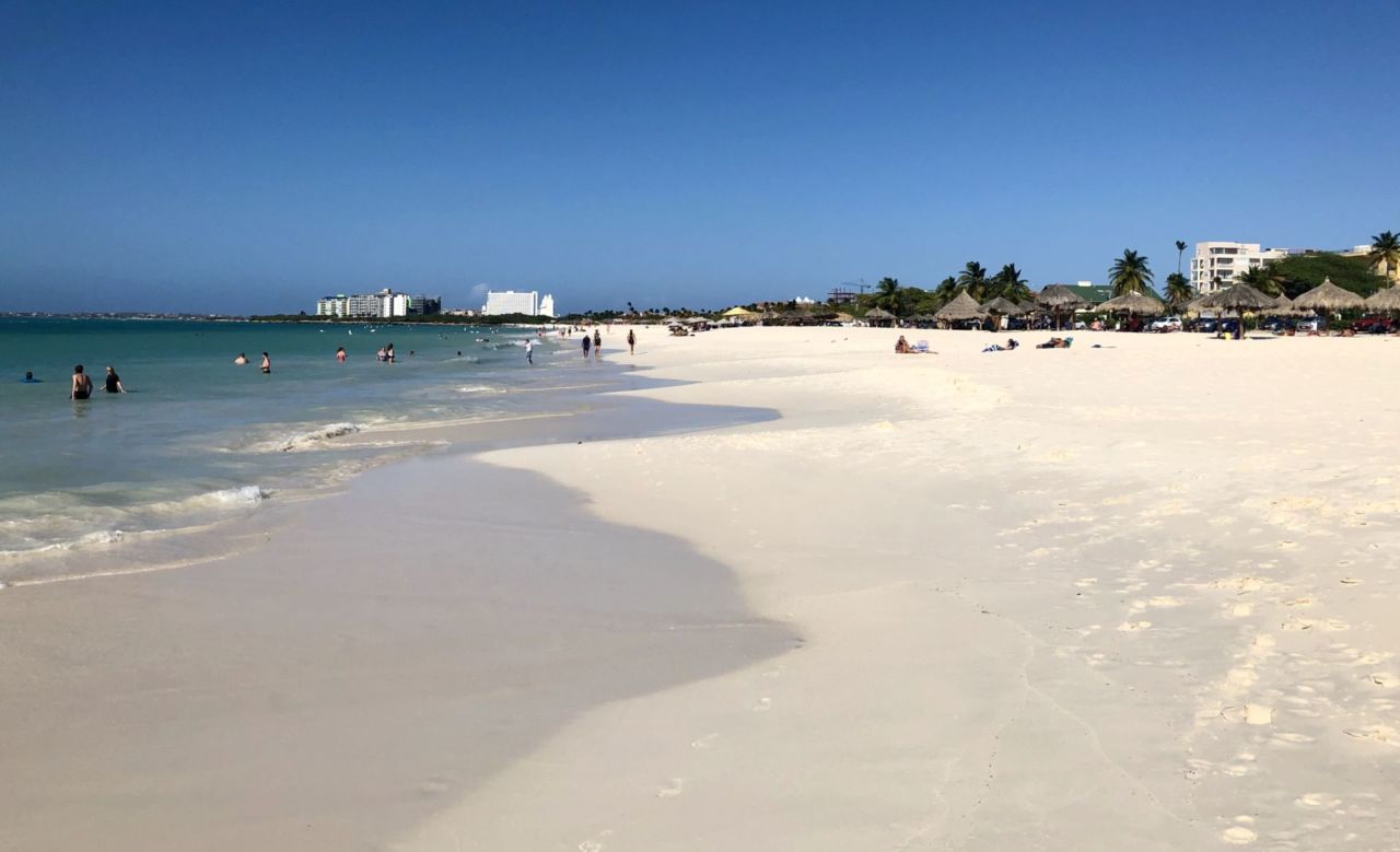 A sandy beach next to a body of water